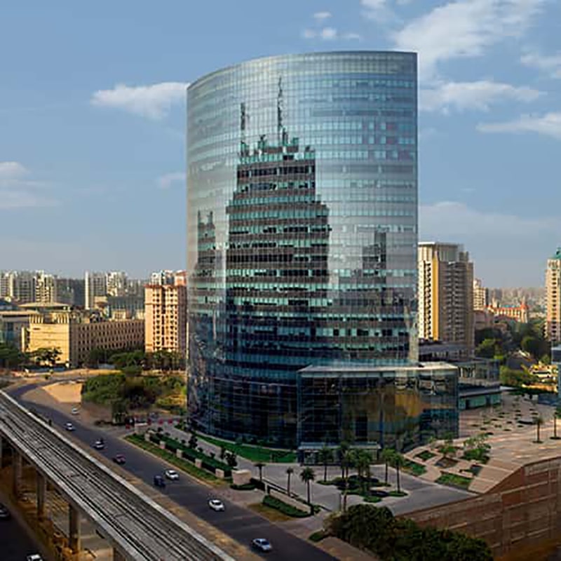 Aerial daytime view of the curved glass tower