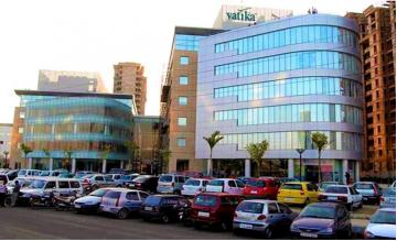 Exterior view of Vatika Atrium Block B with parking forecourt