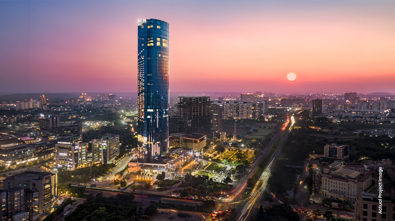 Sunset skyline view showing the tower's height relative to the city