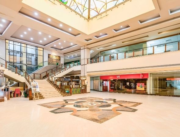 Atrium lobby with grand staircase and marble mosaic floor
