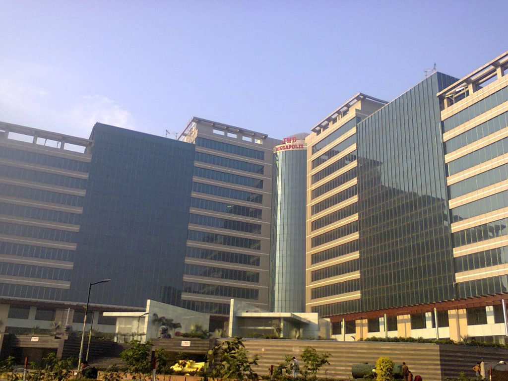 Exterior view of JMD Megapolis tower with signage