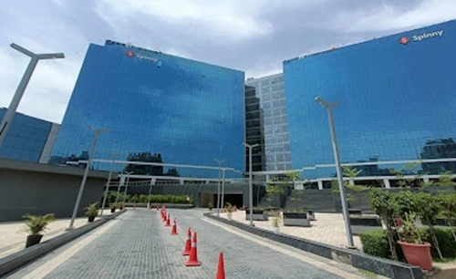 Alternate exterior view of the towers with tenant (Spinny) signage