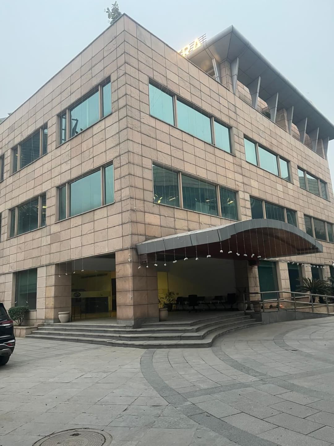 Street-level view of a commercial office building in Sector 32, Gurugram