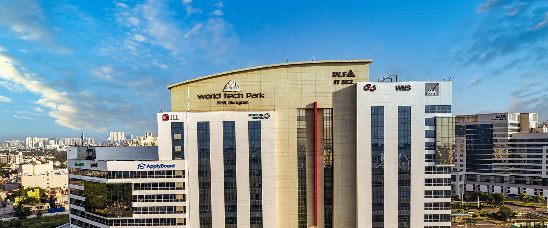 DLF World Tech Park building exterior with rooftop signage, NH-8, Gurugram